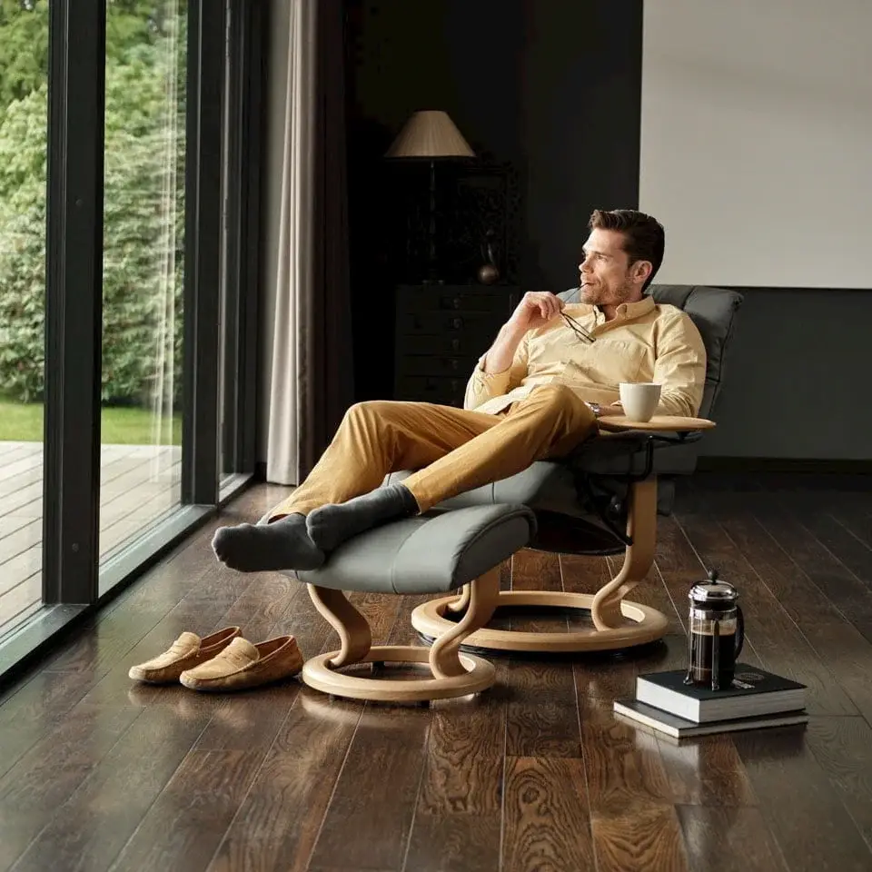 MayfairClassicMan960c960 The Most Comfortable Stressless Stressless Mayfair chair with a rich wooden background, highlighting its premium design and craftsmanship